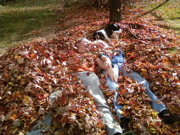 Kathleen, Breighton, and dog Tessa in leaves
